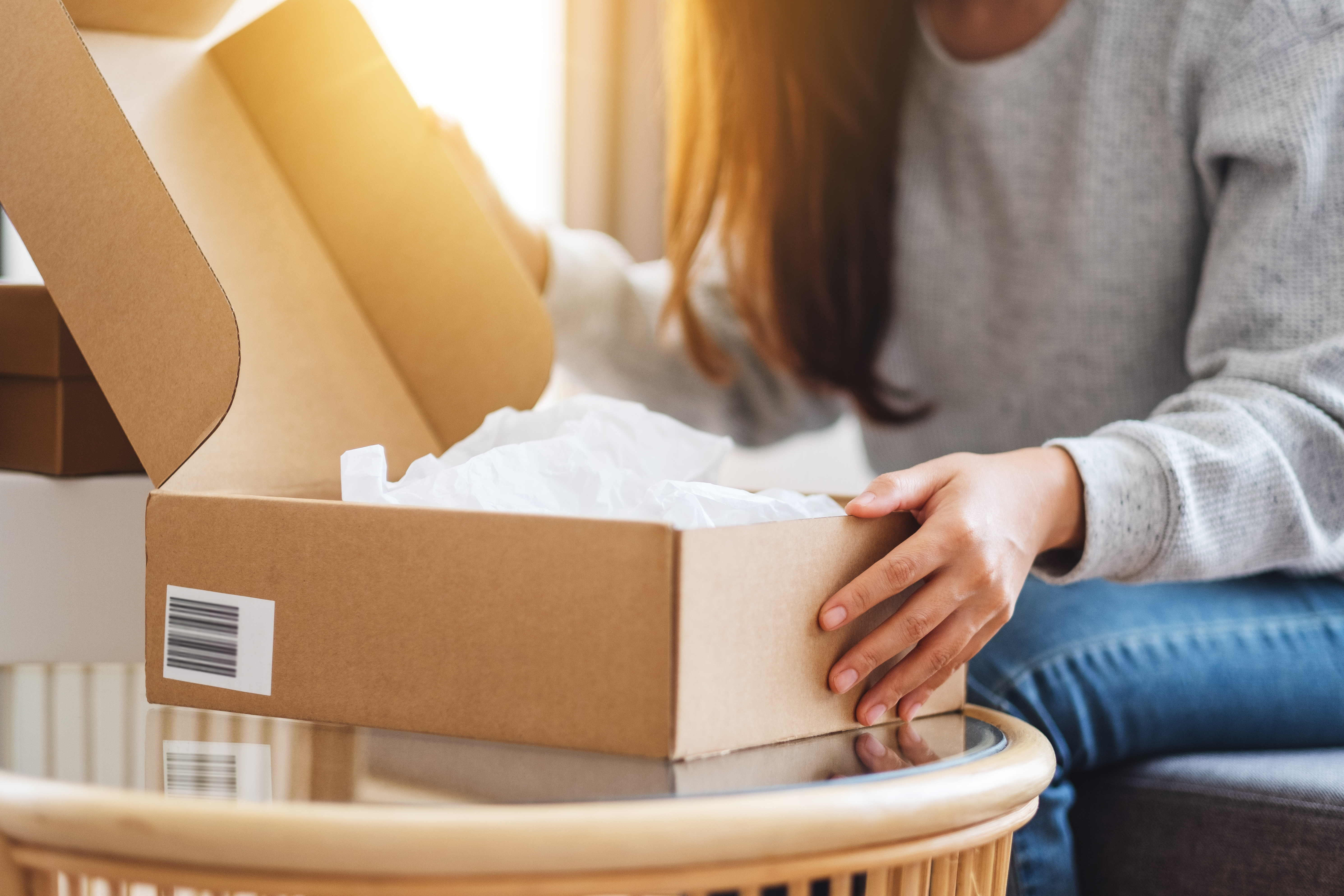 A woman opening up a package | Source: Shutterstock