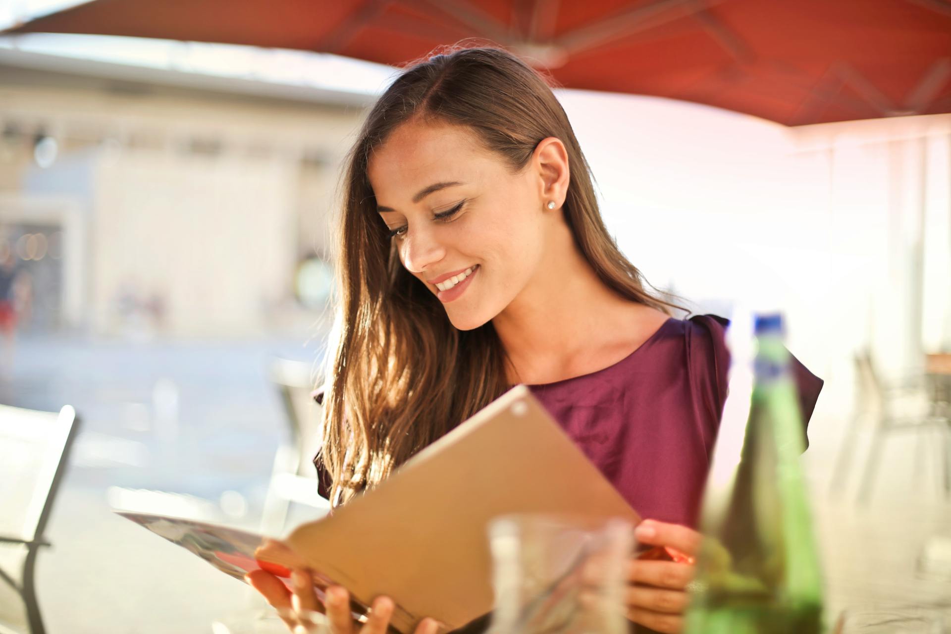 Woman looking at a menu | Source: Pexels