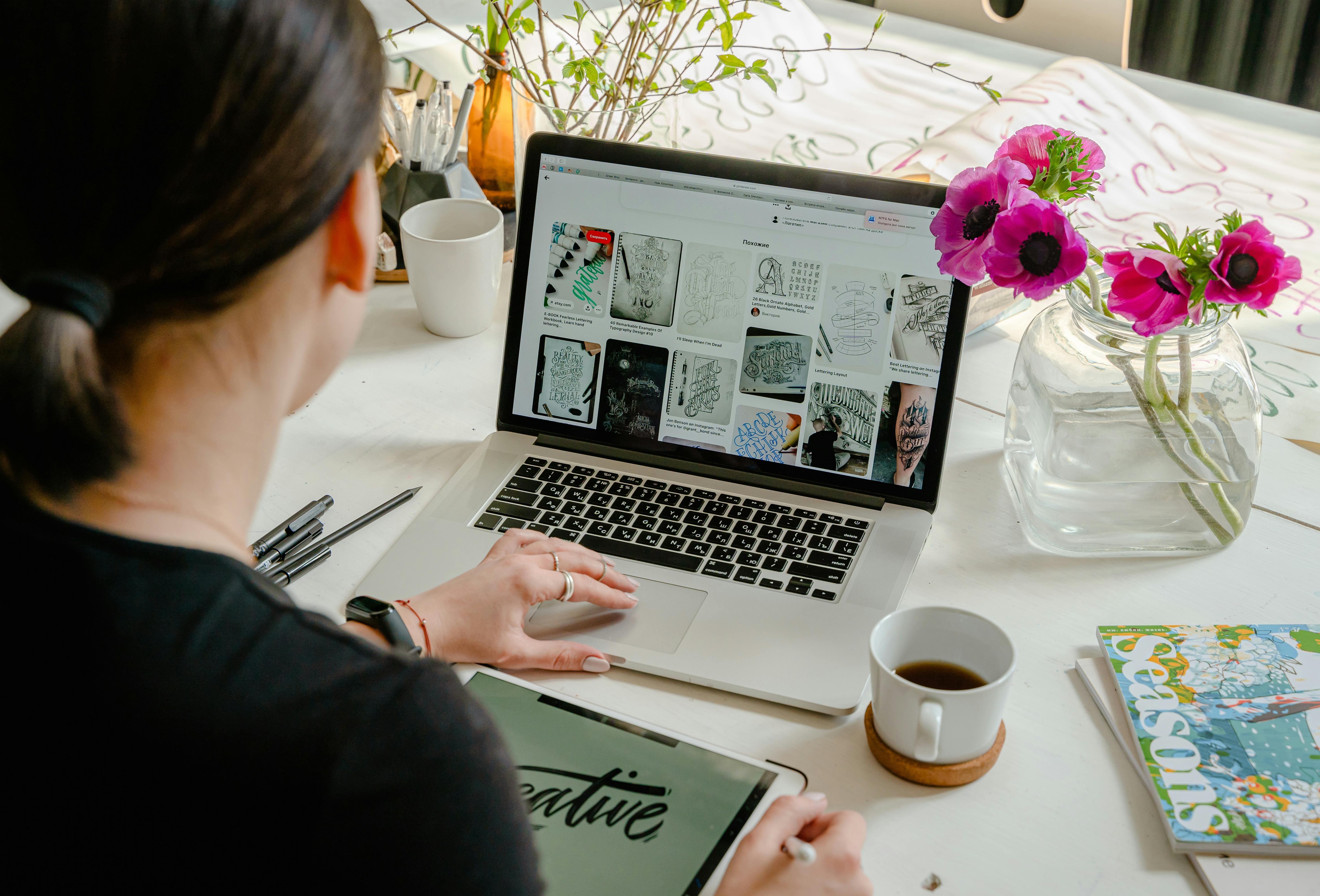 A woman browses through images on a laptop | Source: Pexels