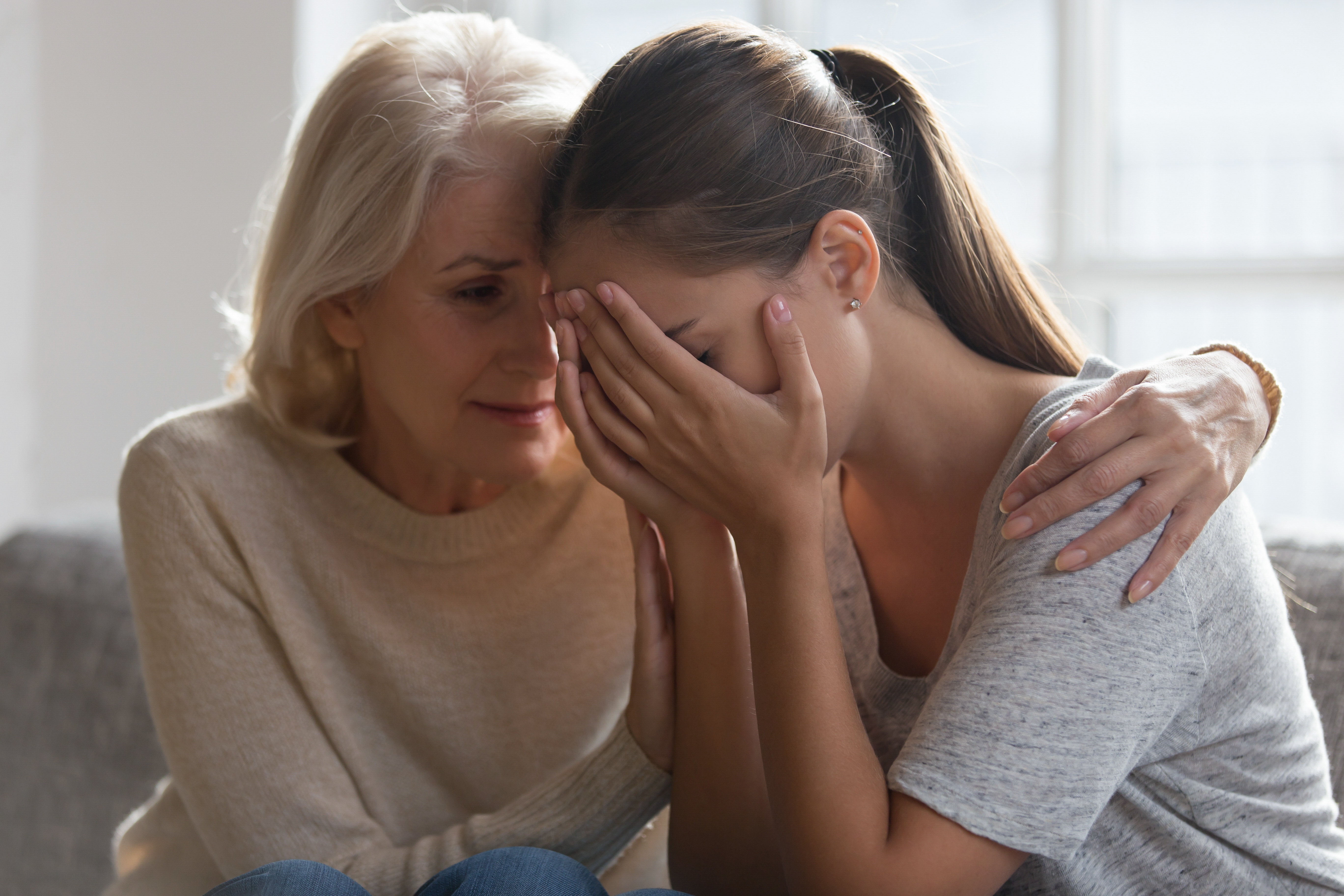 A mother comforting her daughter | Source: Shutterstock