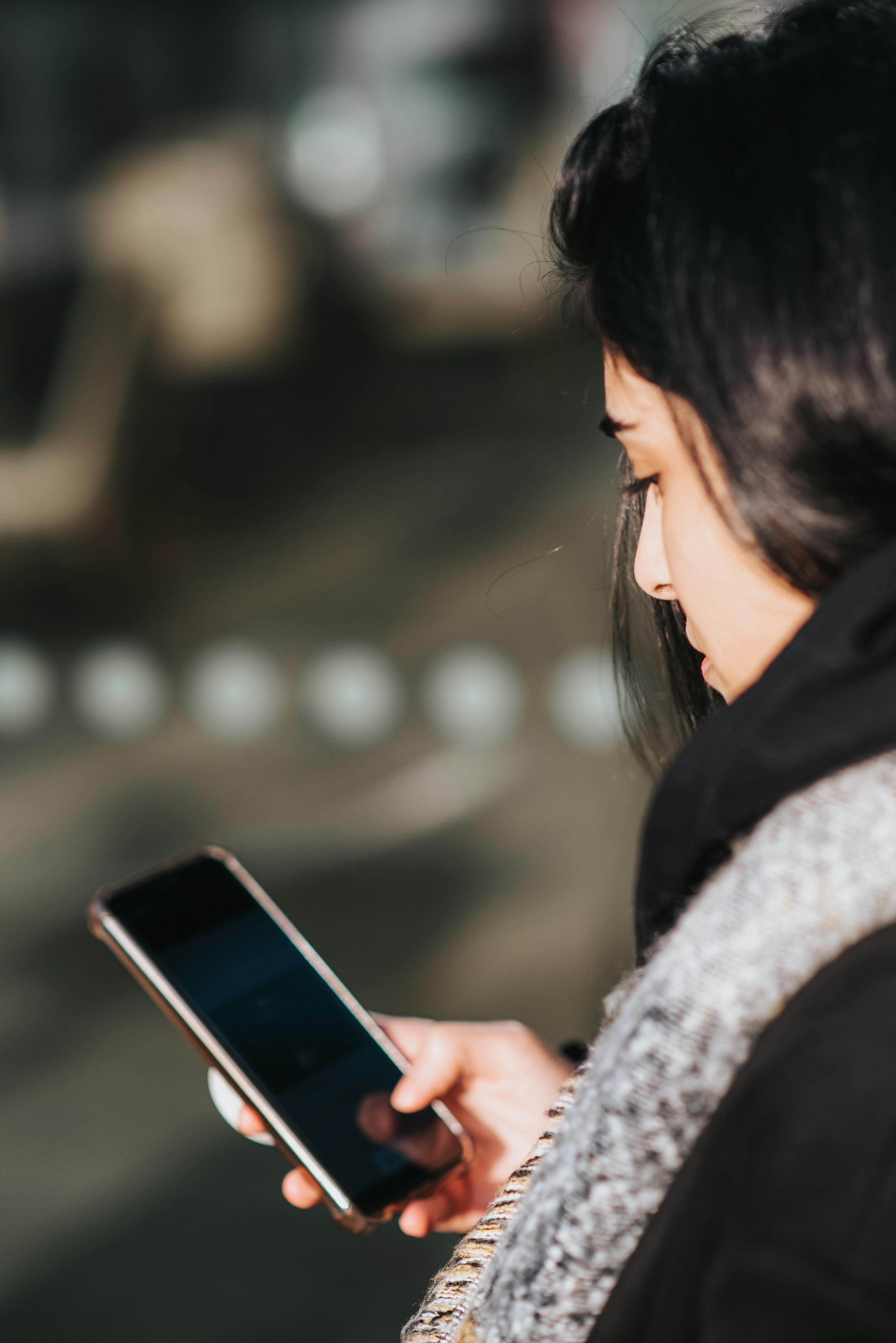 A woman on her phone | Source: Pexels