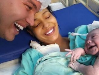 A Newborn Baby Smiles at Father Showing Everyone What True Love Is