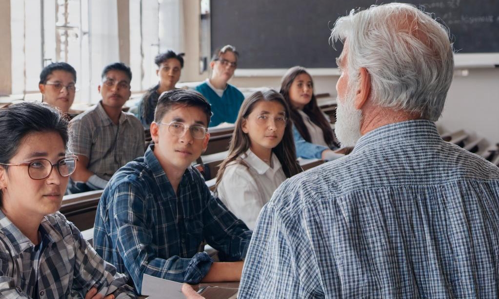 John pushing on with this studies, making a class presentation | Source: Midjourney