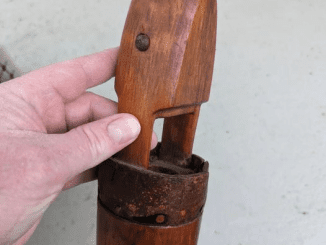 Wood and leather object left in our house when we bought it. What is it?