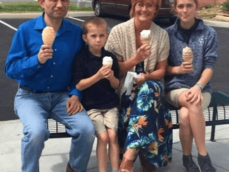 A woman stepped up to take this happy family photo after they had ice cream.